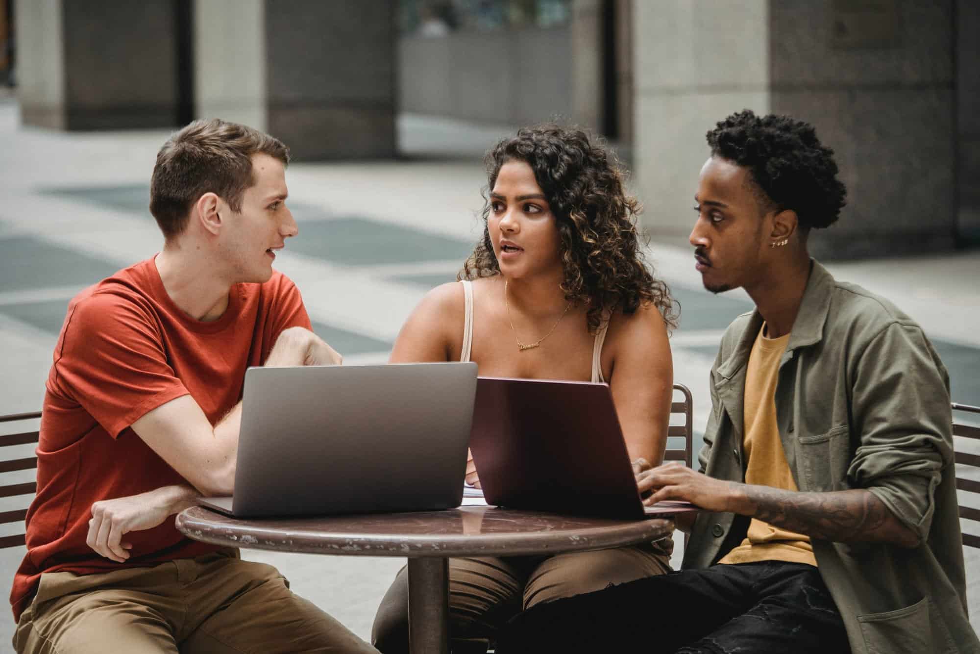 Small group sitting at a table outside